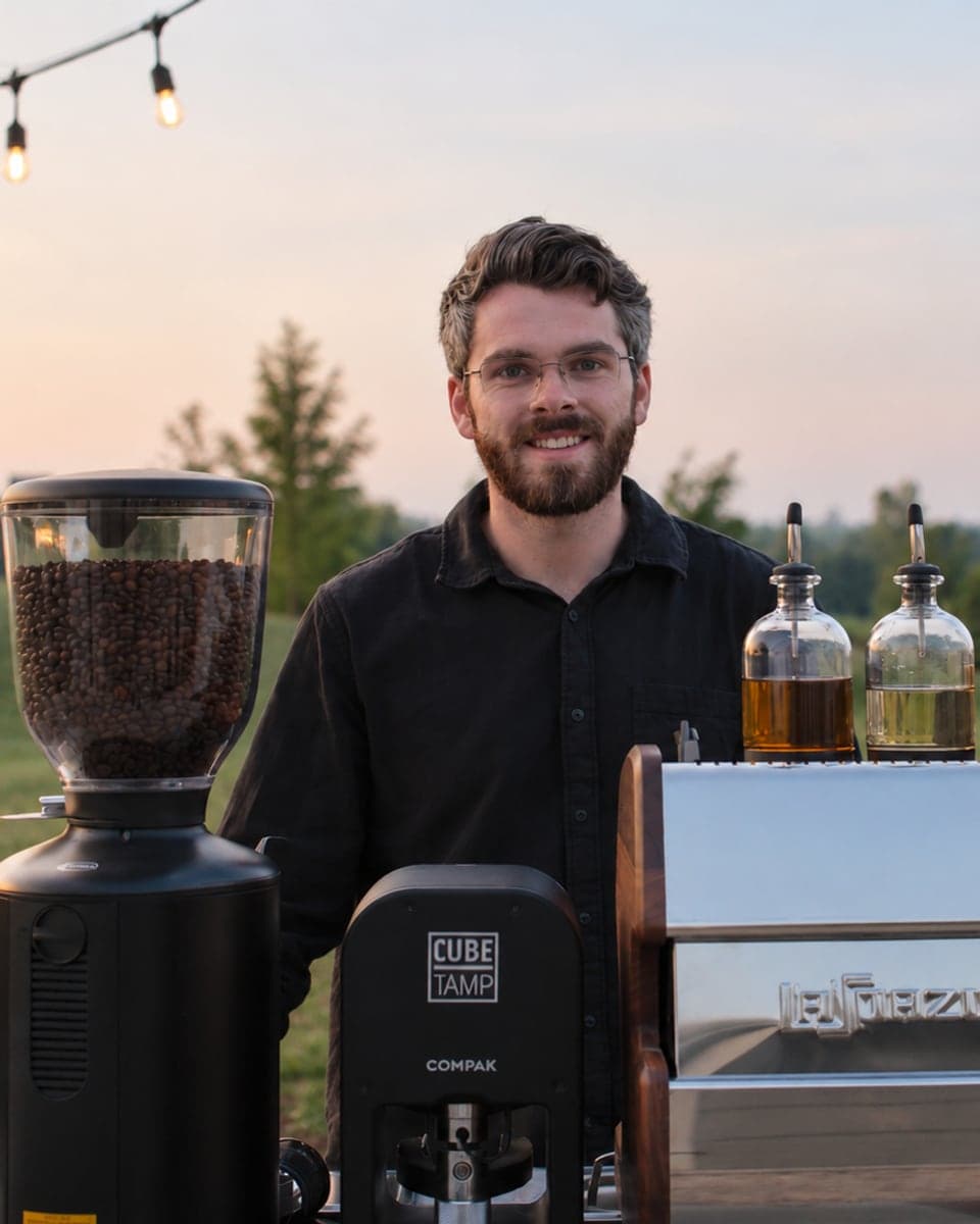 Spencer Selig behind the Wooden Cow Coffee cart